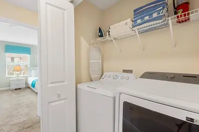 a laundry room with a washer and dryer at 4978 Luxurious 4BR Sunshine Getaway at Storey Lake in Kissimmee