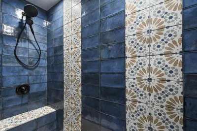a bathroom with a shower with blue tiles at Spring-Fed Lake King Suite Pet Friendly in Orlando