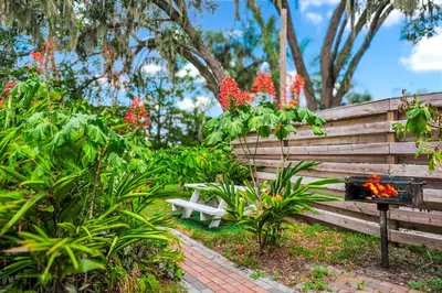 a wooden fence with a bench in a garden at Spring-Fed Lake King Suite Pet Friendly in Orlando
