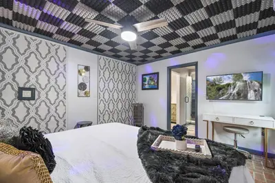a bedroom with a bed and a ceiling fan at Spring-Fed Lake King Suite Pet Friendly in Orlando