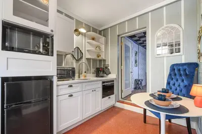 a kitchen with white cabinets and a table at Spring-Fed Lake King Suite Pet Friendly in Orlando