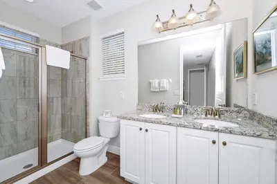 a bathroom with a toilet and a sink and a shower at Marvelous Home With Private Pool And Waterpark Access Near Disney At Encore Resorts Reunion - 131La in Kissimmee