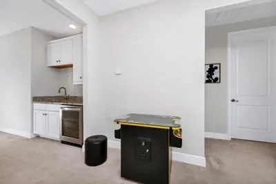 a kitchen with a trashcan in the middle of a room at Marvelous Home With Private Pool And Waterpark Access Near Disney At Encore Resorts Reunion - 131La in Kissimmee