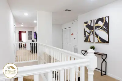 a white staircase with white railings in a house at Amazing 6bd Resort Home Pool & Near Disney in Kissimmee