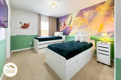 a bedroom with two beds and a disney mural at Amazing 6bd Resort Home Pool & Near Disney in Kissimmee