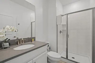 a bathroom with a sink and a toilet and a shower at Modern design near Disney Top resort in Kissimmee