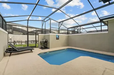 an indoor swimming pool with a glass ceiling at Modern design near Disney Top resort in Kissimmee