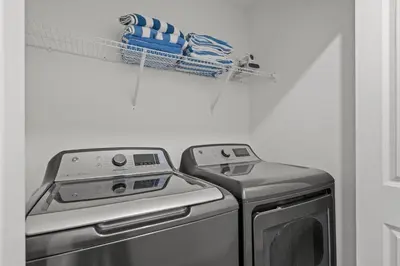a kitchen with a washing machine and a drying rack at Modern design near Disney Top resort in Kissimmee