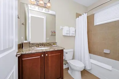 a bathroom with a toilet and a sink and a shower at Spacious Home Near Disney With Game And Themed Rooms With Waterpark & Resort Access At Encore Resorts Reunion - 581La in Kissimmee