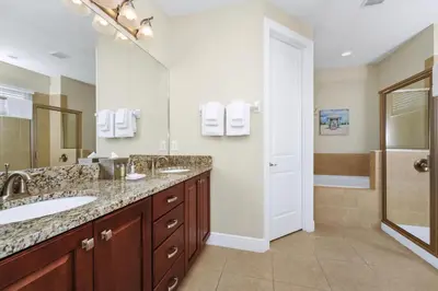 a bathroom with a double sink and a shower at Spacious Home Near Disney With Game And Themed Rooms With Waterpark & Resort Access At Encore Resorts Reunion - 581La in Kissimmee