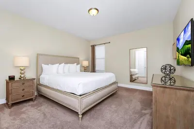 a bedroom with a bed and a flat screen tv at Spacious Home Near Disney With Game And Themed Rooms With Waterpark & Resort Access At Encore Resorts Reunion - 581La in Kissimmee