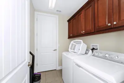a laundry room with a white washer and dryer at Spacious Home Near Disney With Game And Themed Rooms With Waterpark & Resort Access At Encore Resorts Reunion - 581La in Kissimmee