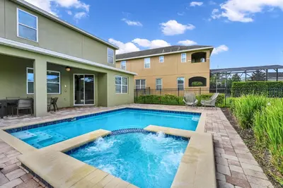 a swimming pool in the backyard of a house at Spacious Home Near Disney With Game And Themed Rooms With Waterpark & Resort Access At Encore Resorts Reunion - 581La in Kissimmee