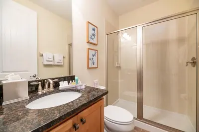 a bathroom with a sink and a shower and a toilet at Lovely Home With Theme Rooms, Game Room With Waterpark & Resort Access Resort Access At Encore Resort- 7705By in Kissimmee
