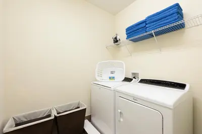 a laundry room with a washer and dryer at Lovely Home With Theme Rooms, Game Room With Waterpark & Resort Access Resort Access At Encore Resort- 7705By in Kissimmee