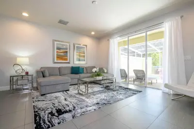 a living room with a couch and a table at Charming 3Bd w Pool Close to Disney at Serenity 1639 in Orlando