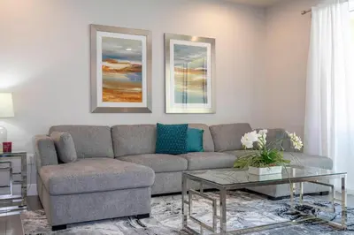 a living room with a couch and a table at Charming 3Bd w Pool Close to Disney at Serenity 1639 in Orlando