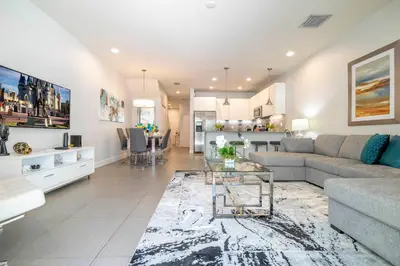 a living room with a couch and a table at Charming 3Bd w Pool Close to Disney at Serenity 1639 in Orlando