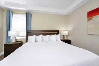 a bedroom with a large white bed with two night stands at Inviting Home Near Disney With Waterpark & Resort Access At Encore Resort - 7792Sw in Kissimmee