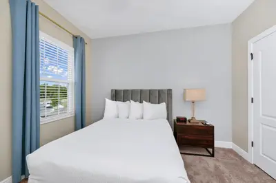 a bedroom with a white bed and a window at Inviting Home Near Disney With Waterpark & Resort Access At Encore Resort - 7792Sw in Kissimmee