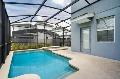 a swimming pool in the backyard of a house at 5 Bedroom 5 Bathroom Storey Lake 4760KC in Kissimmee