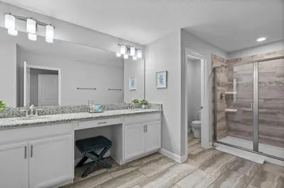 a bathroom with a large sink and a shower at 5 Bedroom 5 Bathroom Storey Lake 4760KC in Kissimmee
