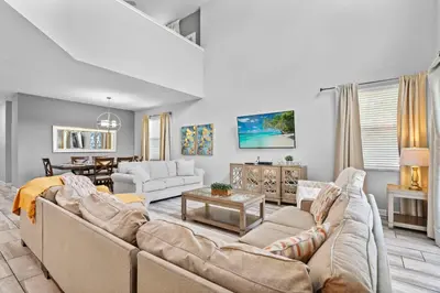 a living room with a couch and a table at 5 Bedroom 5 Bathroom Storey Lake 4760KC in Kissimmee
