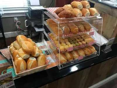 a display case filled with lots of different types of bread at 3 Bedroom 2 Bathroom Lucaya Village 15-103 in Kissimmee