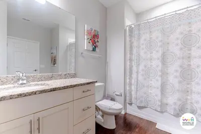 a bathroom with a toilet and a sink and a shower at 4 Bedroom 3 Bathroom Lucaya Village 17-104 in Kissimmee