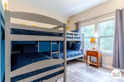 a bedroom with two bunk beds and a table at 4 Bedroom 3 Bathroom Lucaya Village 17-104 in Kissimmee