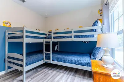 two bunk beds in a room with blue walls at 4 Bedroom 3 Bathroom Lucaya Village 17-104 in Kissimmee
