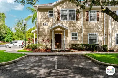 a house with a car parked in front of it at 4 Bedroom 3 Bathroom Lucaya Village 17-104 in Kissimmee