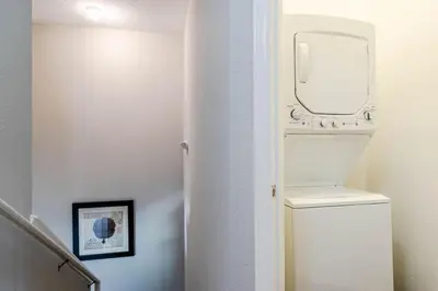 a bathroom with a toilet with a mirror on the wall at 4 Bedroom 3 Bathroom Lucaya Village 17-104 in Kissimmee