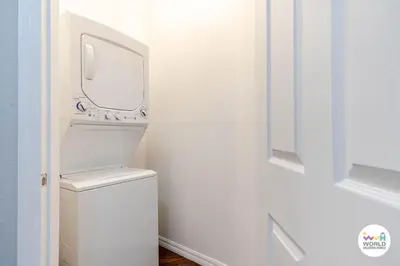 a white bathroom with a toilet and a sink at 4 Bedroom 3 Bathroom Lucaya Village 17-104 in Kissimmee