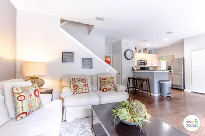 a living room with a couch and a table at 4 Bedroom 3 Bathroom Lucaya Village 17-104 in Kissimmee