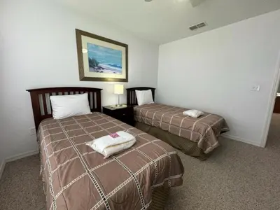 a hotel room with two beds with towels on them at 4 Bedroom 3 Bathroom Villas At Seven Dwarfs 8-107 in Kissimmee