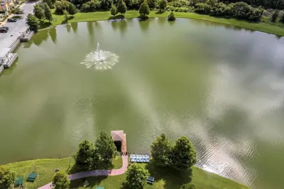 an aerial view of a large lake with a fountain at 4 Bedroom 3 Bathroom Villas At Seven Dwarfs 8-107 in Kissimmee