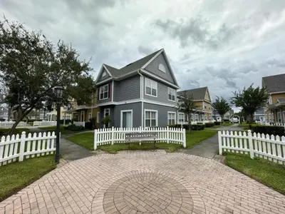 a house with a white fence in front of it at 4 Bedroom 3 Bathroom Villas At Seven Dwarfs 8-107 in Kissimmee