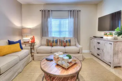 a living room with a couch and a table at 4 Bedroom 3 Bathroom Storey Lake 4895CT in Kissimmee