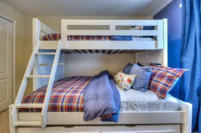 two bunk beds in a room with a bed at 4 Bedroom 3 Bathroom Storey Lake 4895CT in Kissimmee
