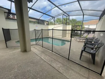 a balcony with a fence and a swimming pool at 4 Bedroom 3 Bathroom Storey Lake 4895CT in Kissimmee