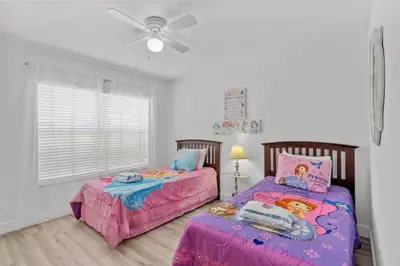 a bedroom with two beds and a ceiling fan at 4 Bedroom 3 Bathroom Villas At Seven Dwarfs 24-102 in Kissimmee