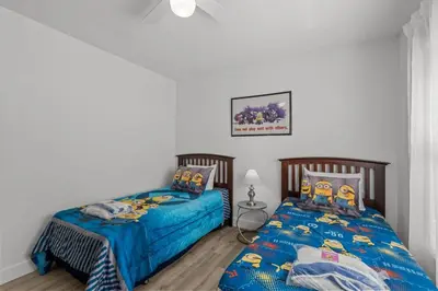 two beds sitting next to each other in a bedroom at 4 Bedroom 3 Bathroom Villas At Seven Dwarfs 24-102 in Kissimmee