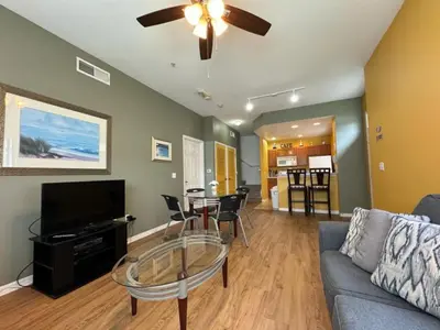 a living room with a couch and a glass table at 4 Bedroom 3 Bathroom Villas At Seven Dwarfs 1-101 in Kissimmee