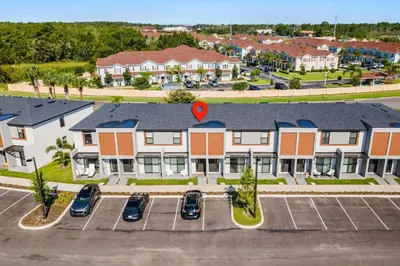 an aerial view of a building with a parking lot at 3 Bedroom 3 Bathroom The Hub At Westside Reserve 3300 TT in Kissimmee