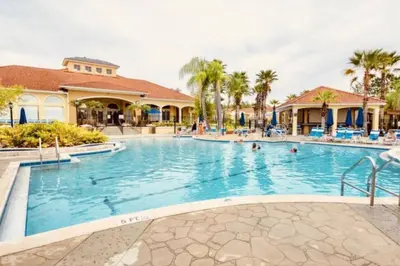 a swimming pool at a resort with people in it at 3 Bedroom 3 Bathroom Terra Verde 4766 in Kissimmee