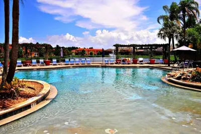 a large swimming pool with blue chairs in a resort at 3 Bedroom 3 Bathroom Terra Verde 4766 in Kissimmee