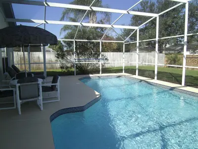 a large swimming pool with a pavilion and anophe at 4 Bedroom Value Plus Home with Private PooI in Orlando