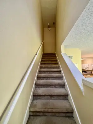 a staircase in an apartment building with a stair case at Grand Emerald 3BR Condo Resort near Disney Parks in Kissimmee
