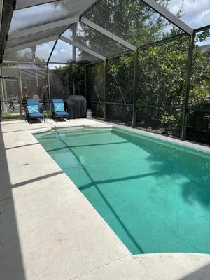 a swimming pool with a glass enclosure and a swimming pool at Shrek's Hideout! - 5 min from Disney! in Kissimmee
